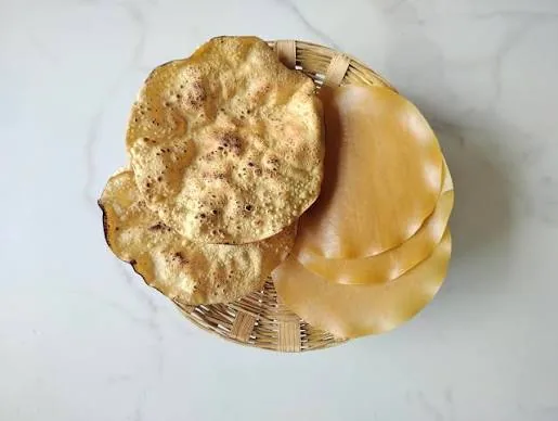Wheat papad, roasted and plain, in a woven basket
